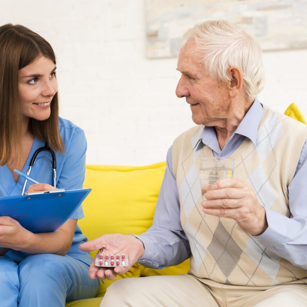 old-man-holding-his-pills-while-talking-nurse